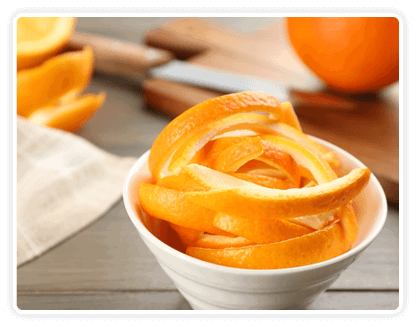 Bowl of sliced organic orange peels on a wooden table, highlighting natural vitamin C and fiber benefits.